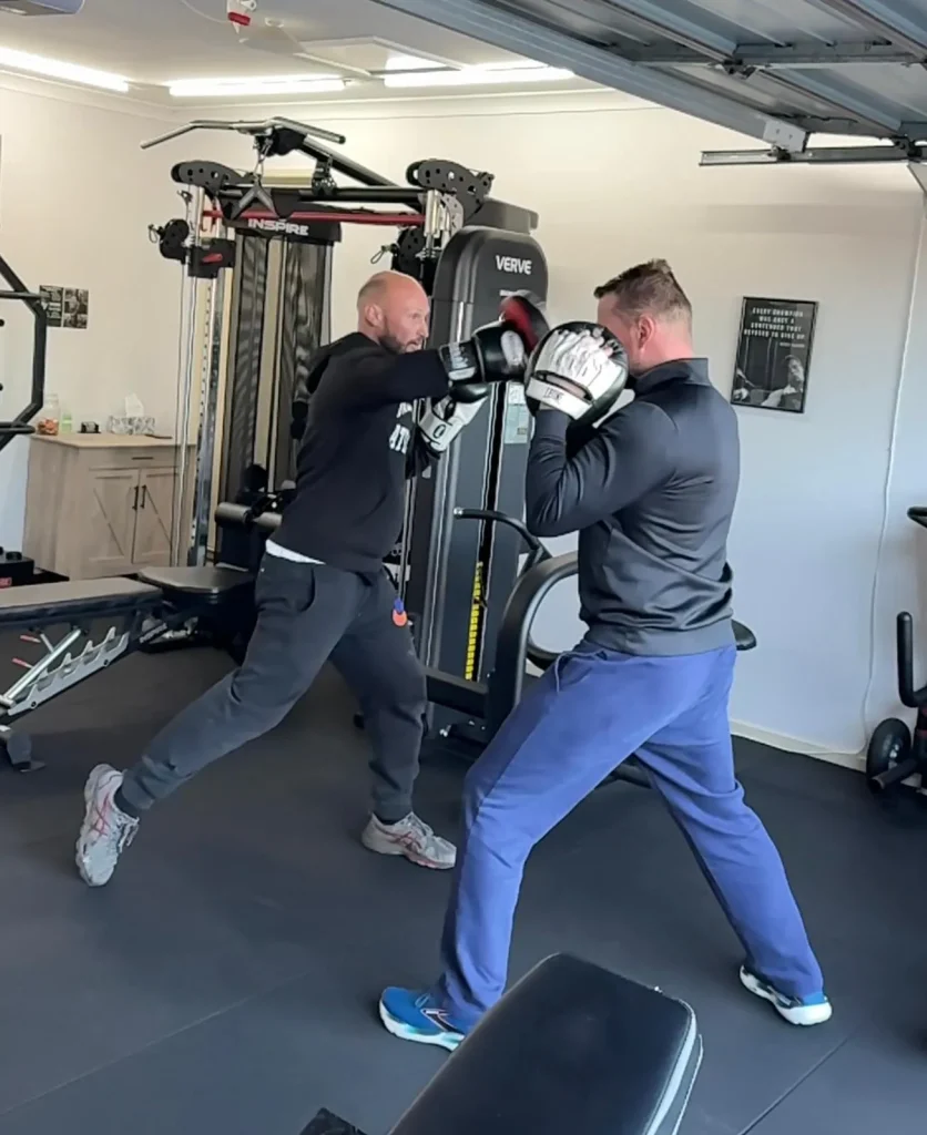 Trainer with client, boxing