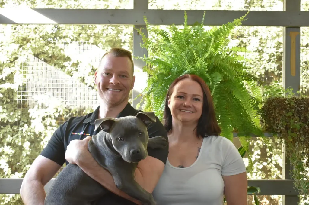 Profile photo of owner, Mark, with fiancé, Alison, and their dog